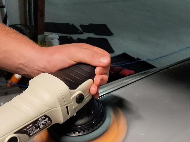 Prime detailer machine-polishing paintwork during paint correction