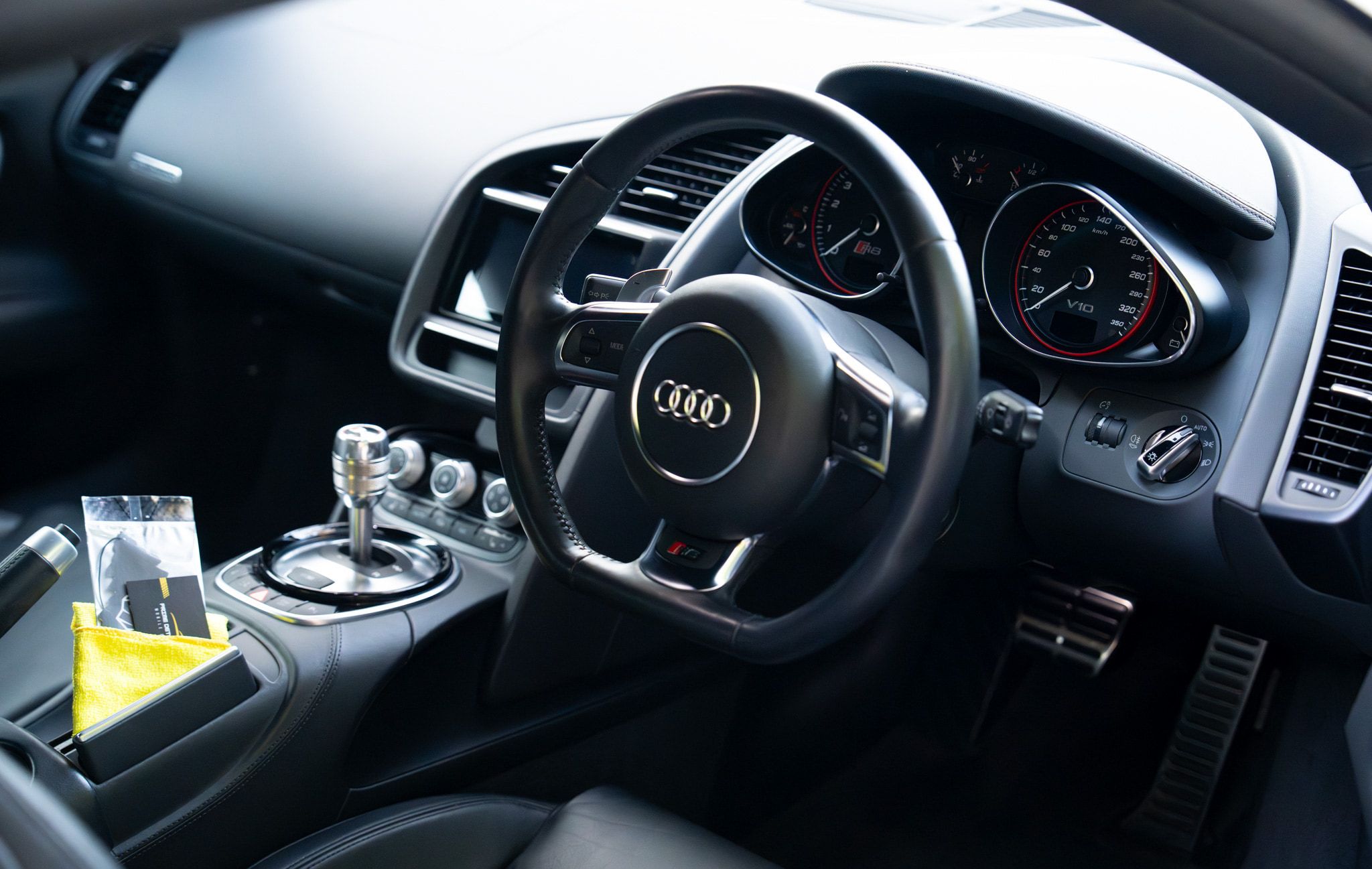 Audi R8 V10 cockpit with a fresh microfibre and a Prime card on the console