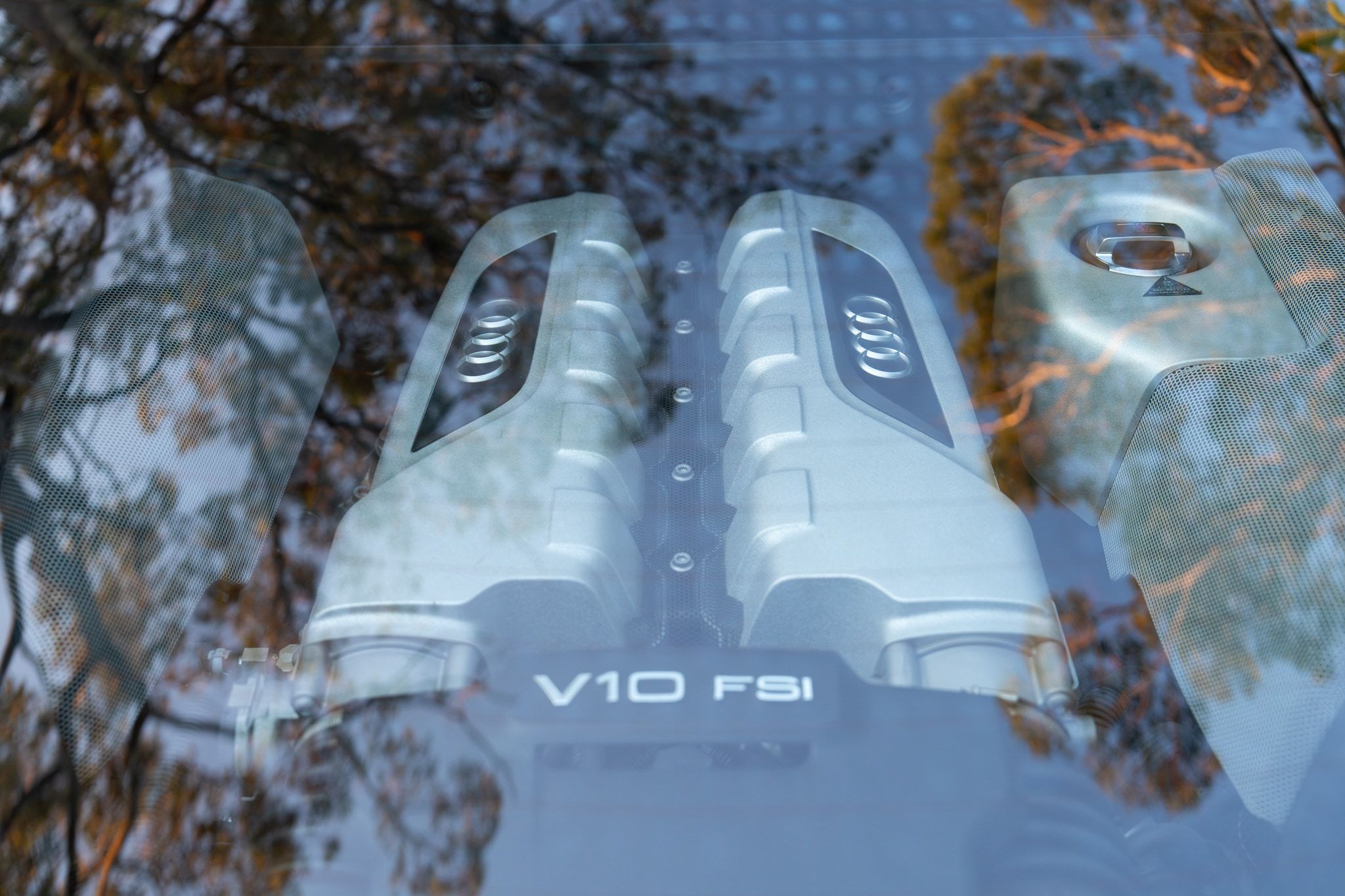 Audi R8 V10 engine bay seen through the rear glass, cleaned and dressed